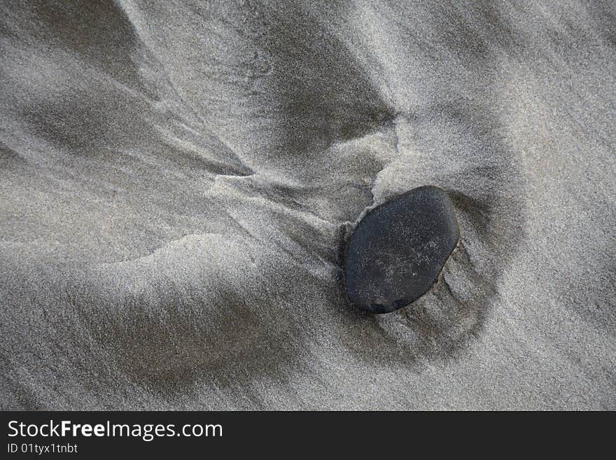 Stone on sand beach and surf track. Stone on sand beach and surf track