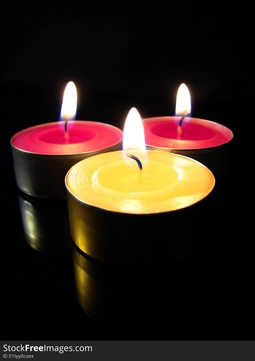 Colorful candles isolated on black background