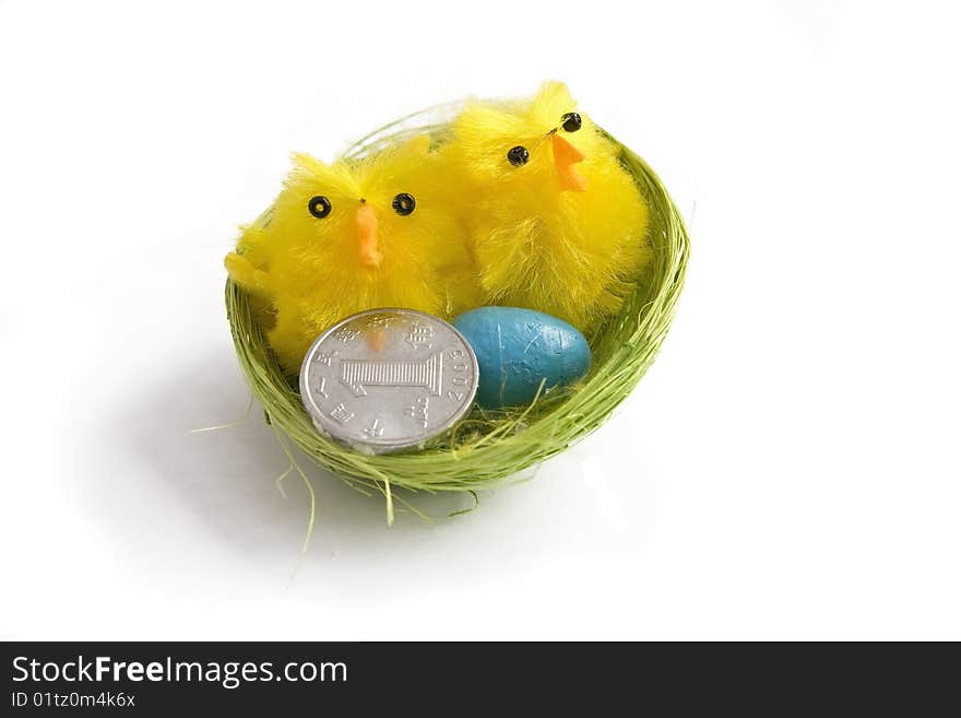 Birds nest with egg and coin isolated on white. Birds nest with egg and coin isolated on white