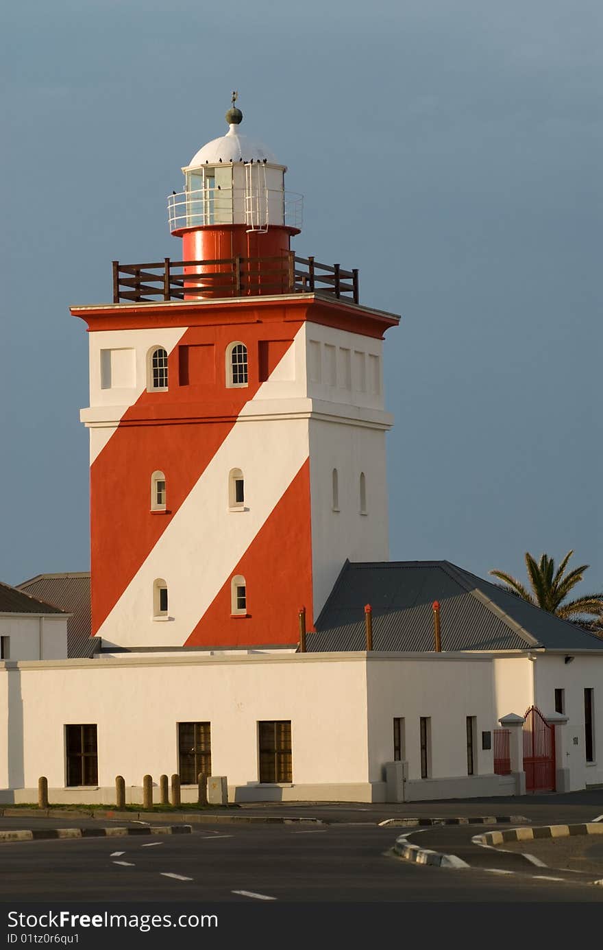 Red and white Lighthouse at sunset