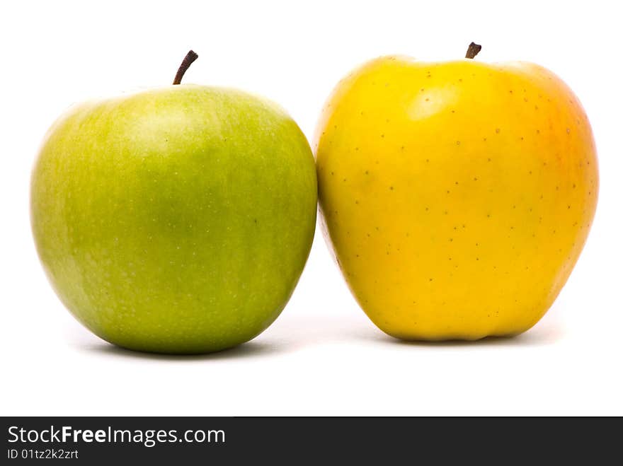 Green and yellow fresh apples on studio white