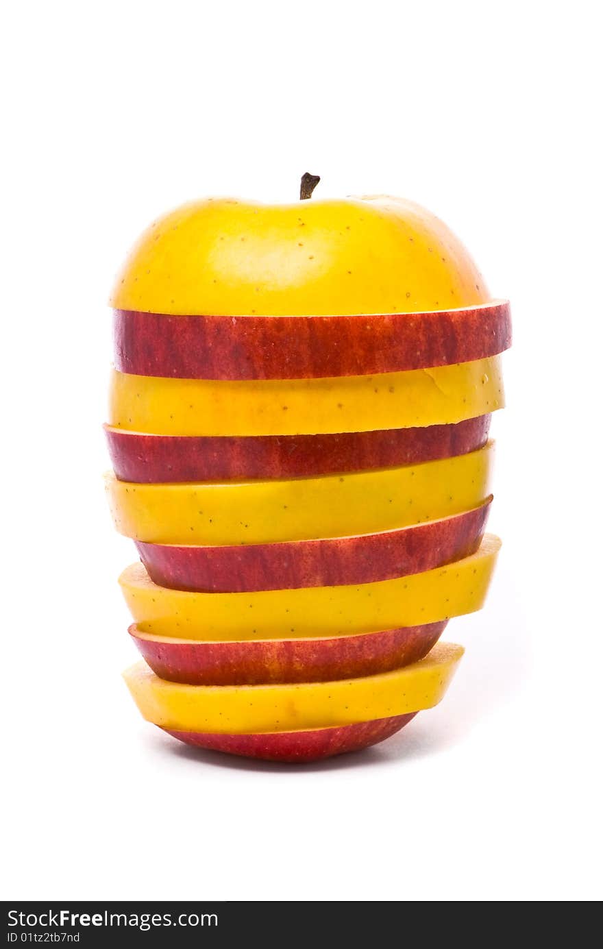 Sliced yellow and red apples on studio white