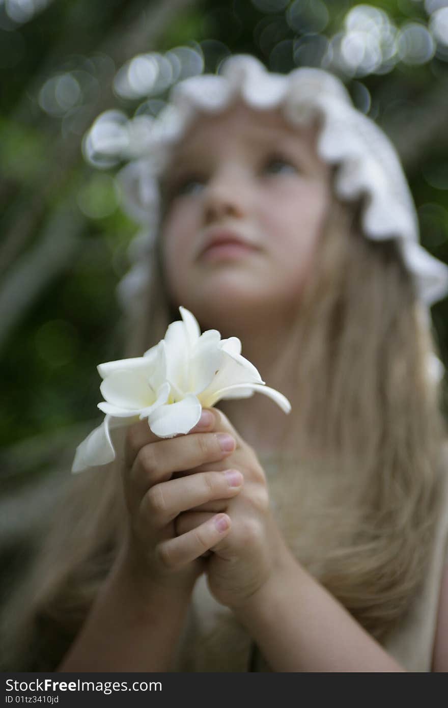 Little praying girl with white flowers in hands. Little praying girl with white flowers in hands