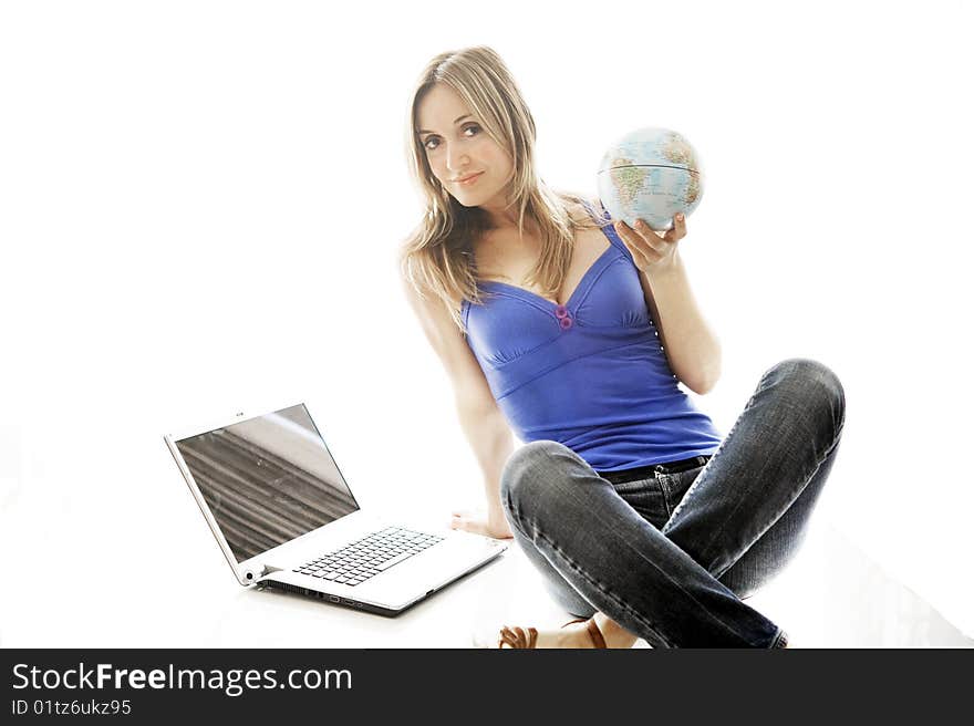 Woman holding a small globe in her hand.