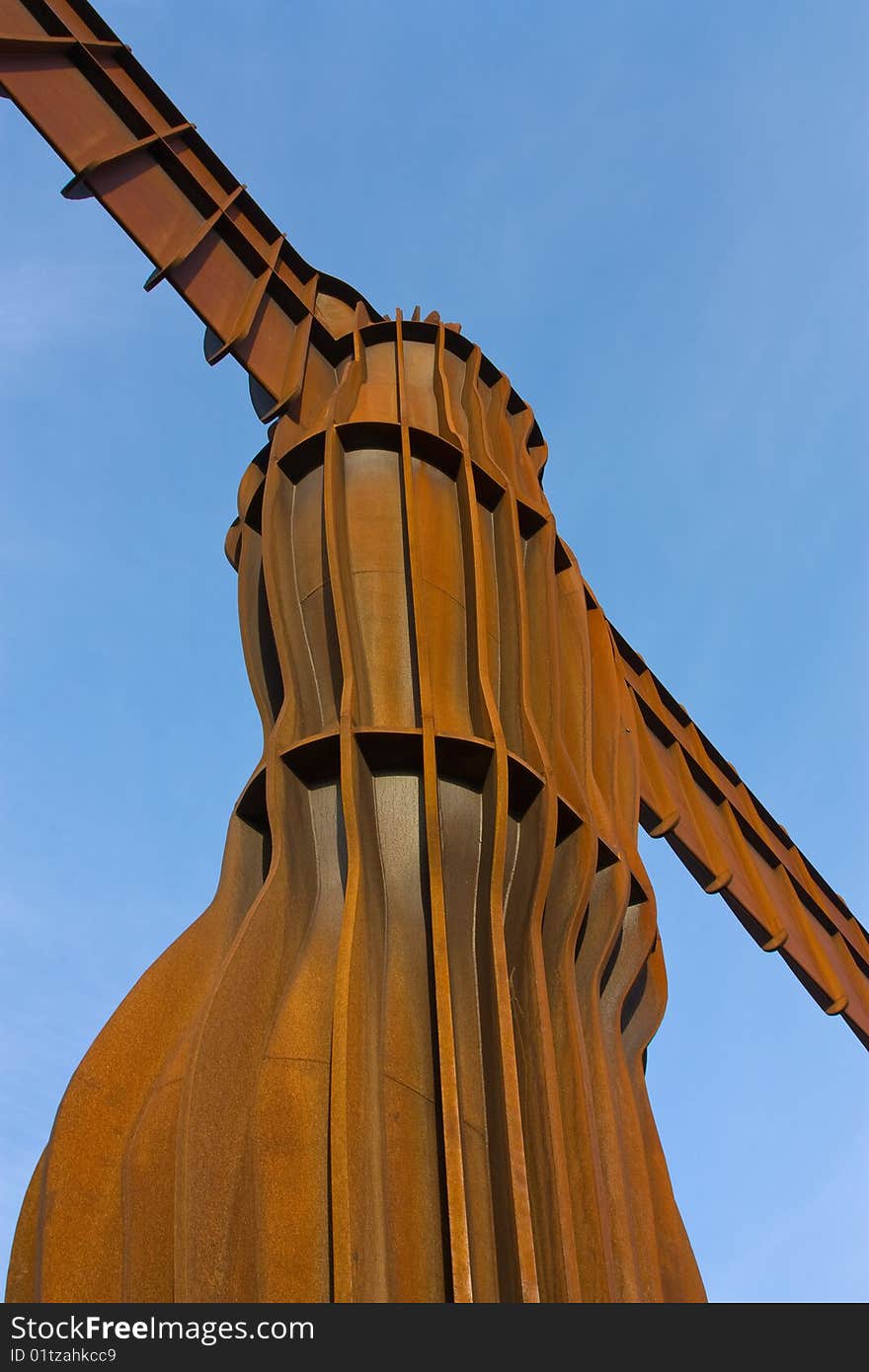 Abstract View of The Angel of the North with wings outstretched against vivid blue sky. Abstract View of The Angel of the North with wings outstretched against vivid blue sky