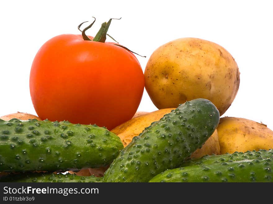 Fresh tomato, cucumbers and potatoes on studio white