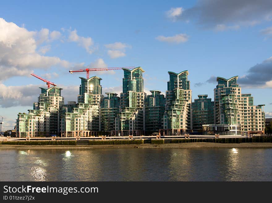 Modern building on a river bank and sky with clouds