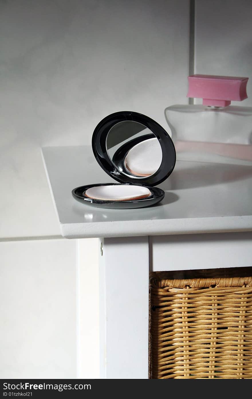 Black makeup box on a white table in the bathroom