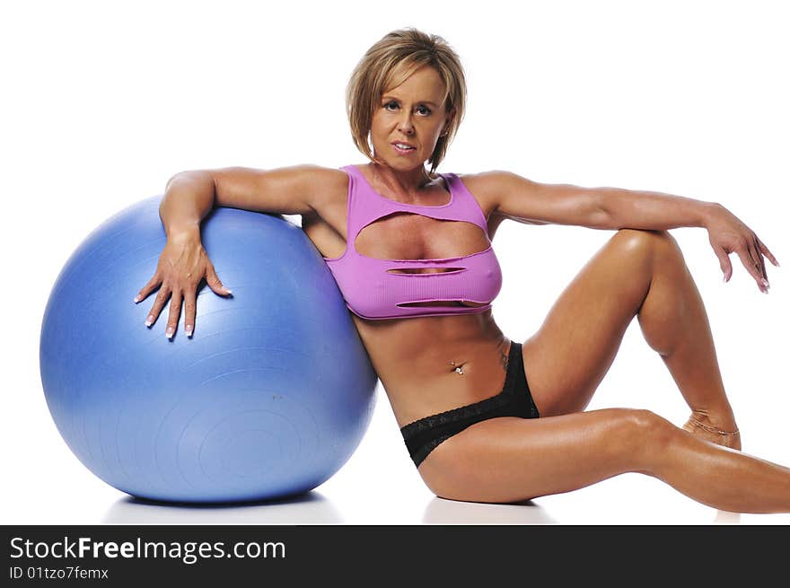 Woman working out using a ball and isolated on white background