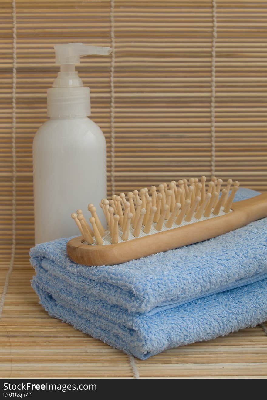 Towels,  wood hairbrush,  and liquid soap. Towels,  wood hairbrush,  and liquid soap