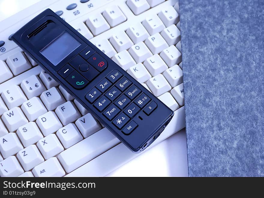 Wireless phone on a computer keyboard