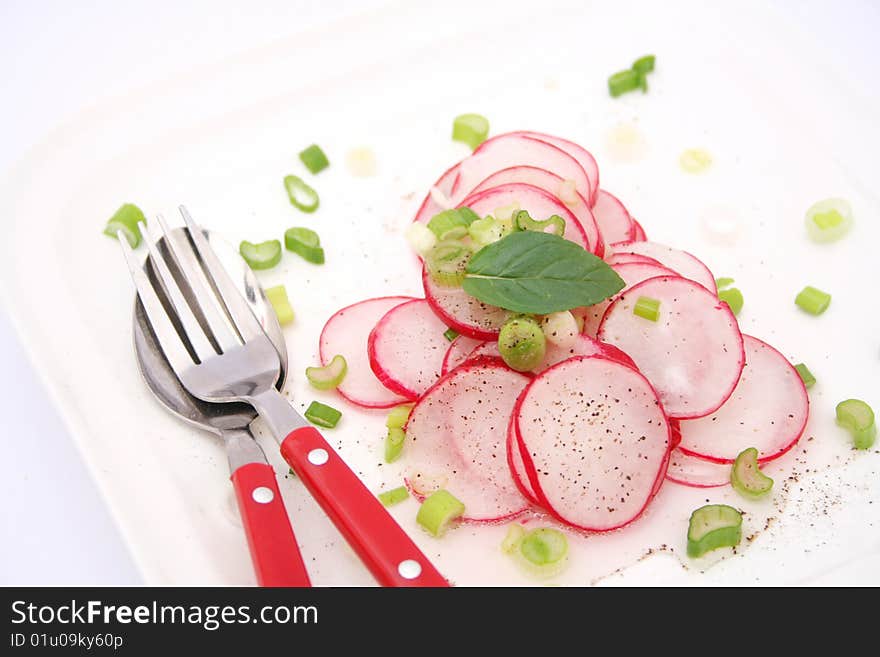 A fresh salad of red reddish on a plate