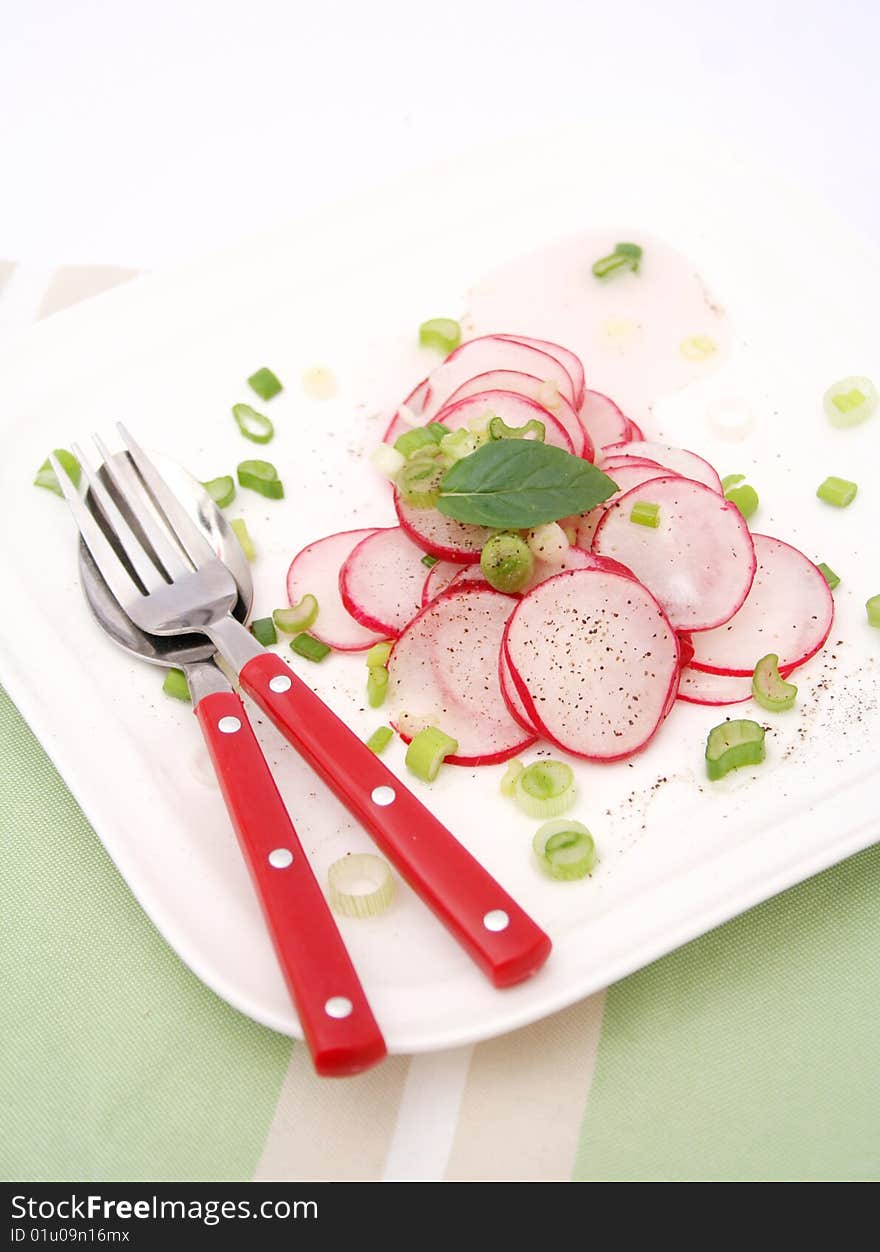 A fresh salad of red reddish on a plate