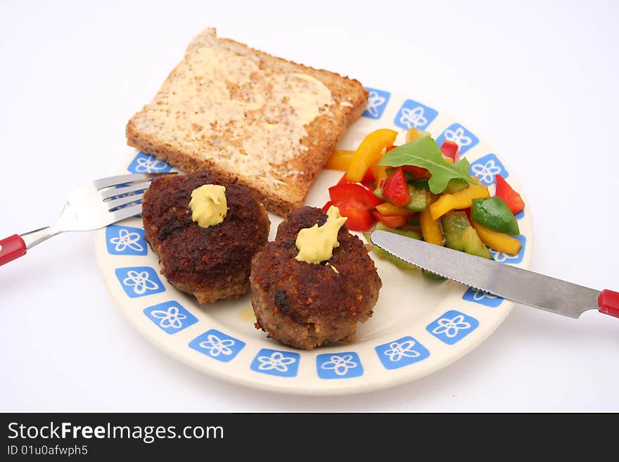 A snack of meatballs with salad of peppers