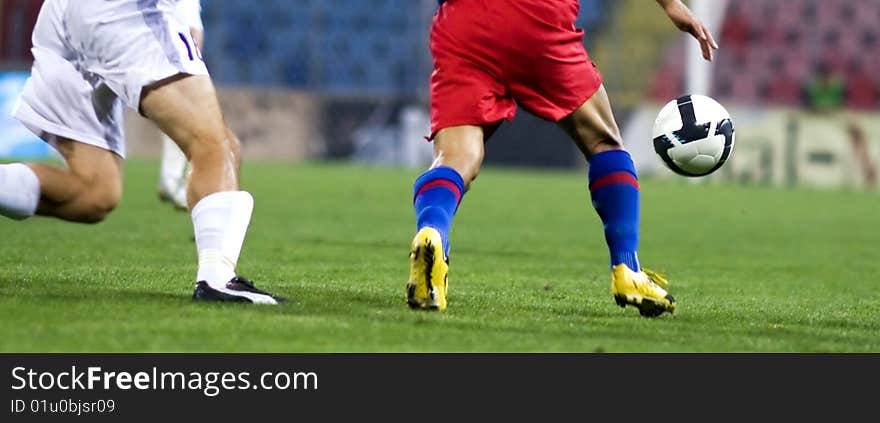 Soccer players fighting for the ball