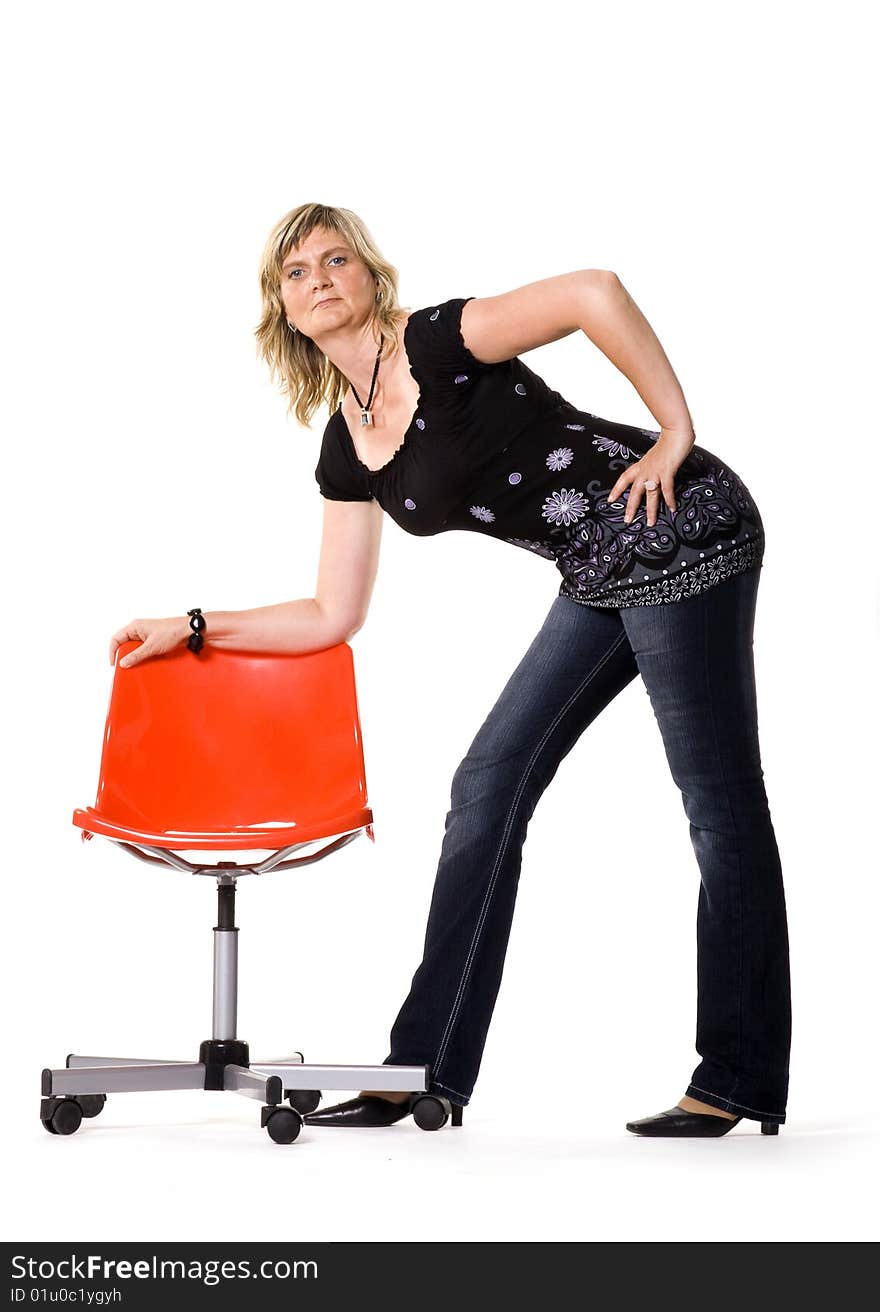 Beautiful middle aged woman posing with red chair