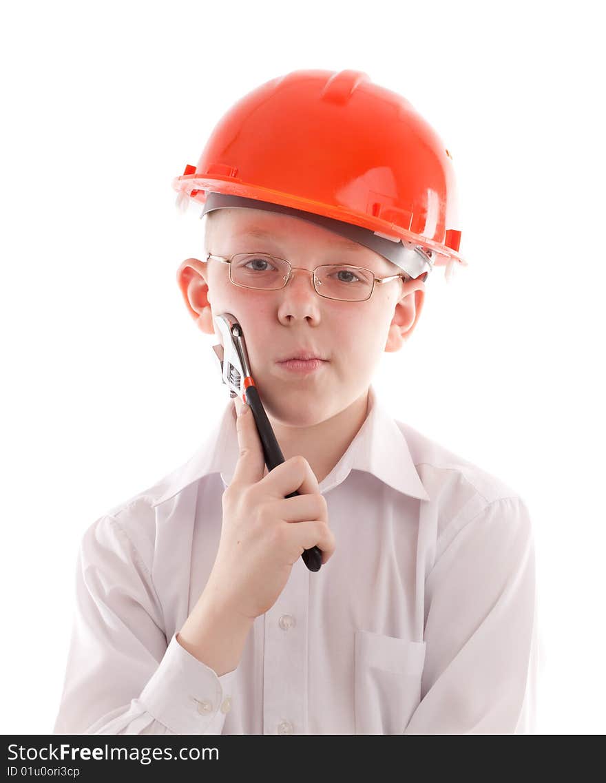 Pensive teenager in protective helmet hold adjustable spanner. Pensive teenager in protective helmet hold adjustable spanner