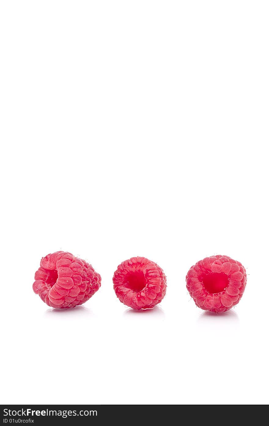 Three Fresh Raspberries On White