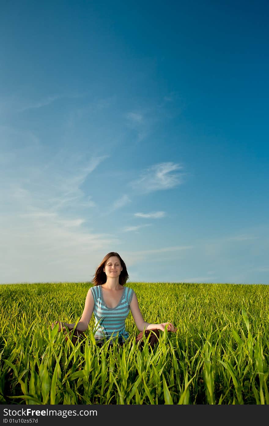 Woman on green field under blue skies. Woman on green field under blue skies