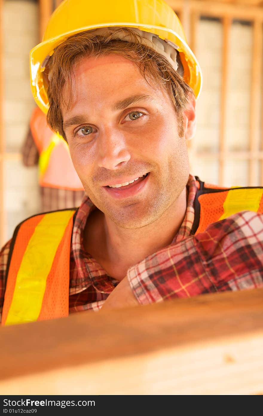 A closeup of a construction worker with a hard hat. A closeup of a construction worker with a hard hat