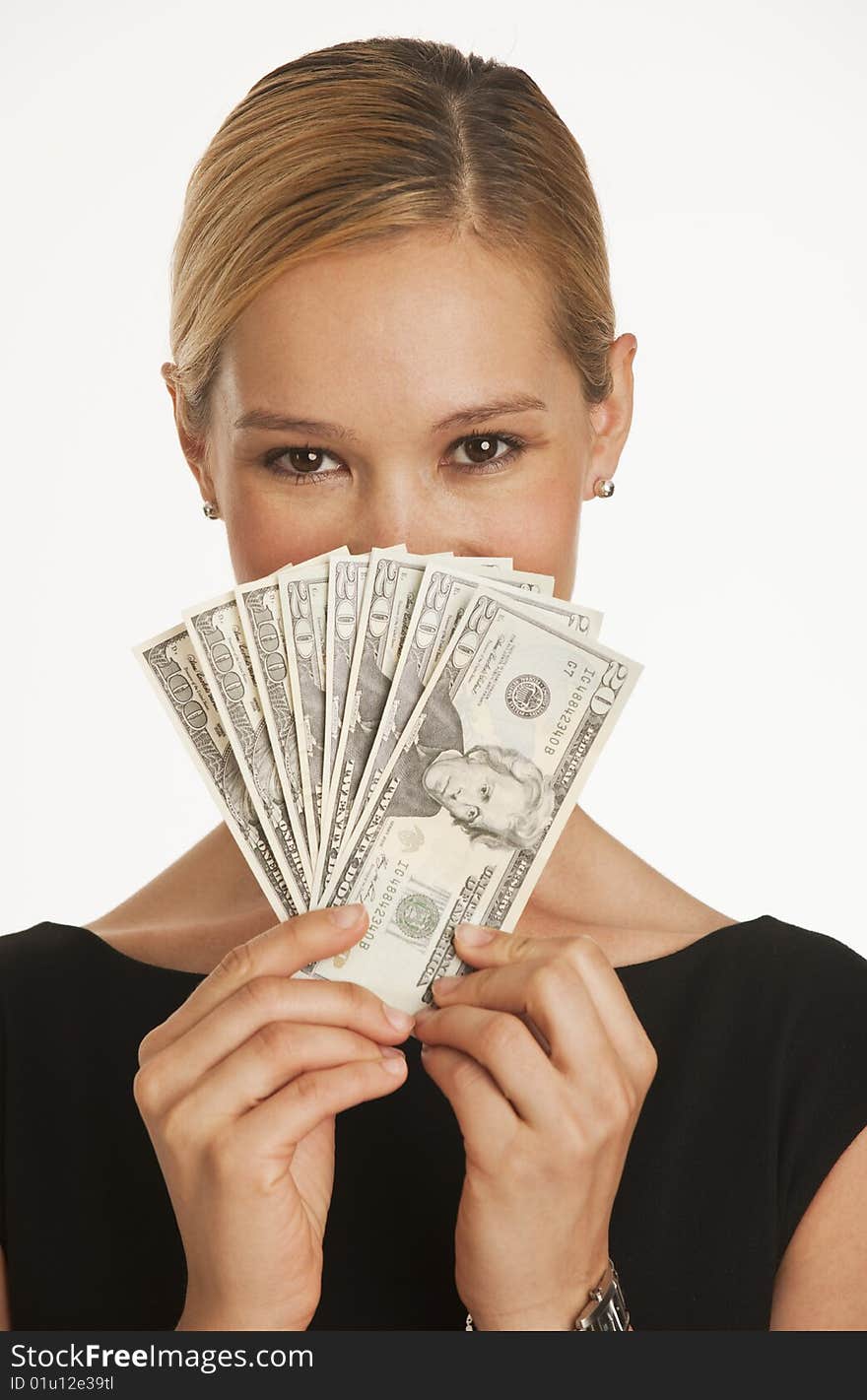 Businesswoman holding up hundreds and twenty dollars in front of her face. Businesswoman holding up hundreds and twenty dollars in front of her face