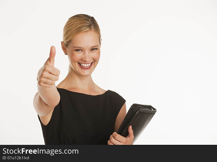 Businesswoman giving thumbs up to camera with white seamless background