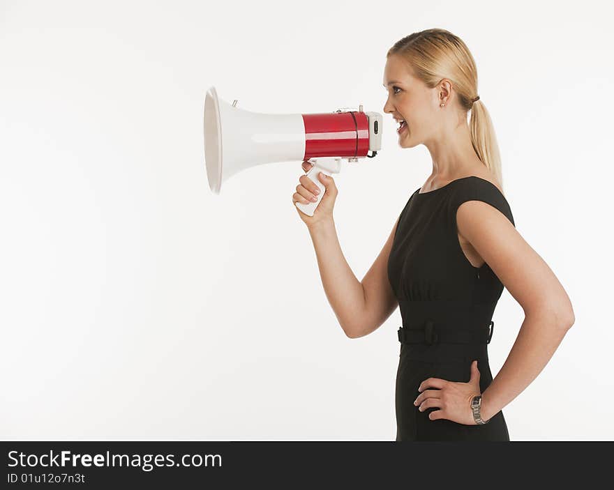 Businesswoman yelling into megaphone