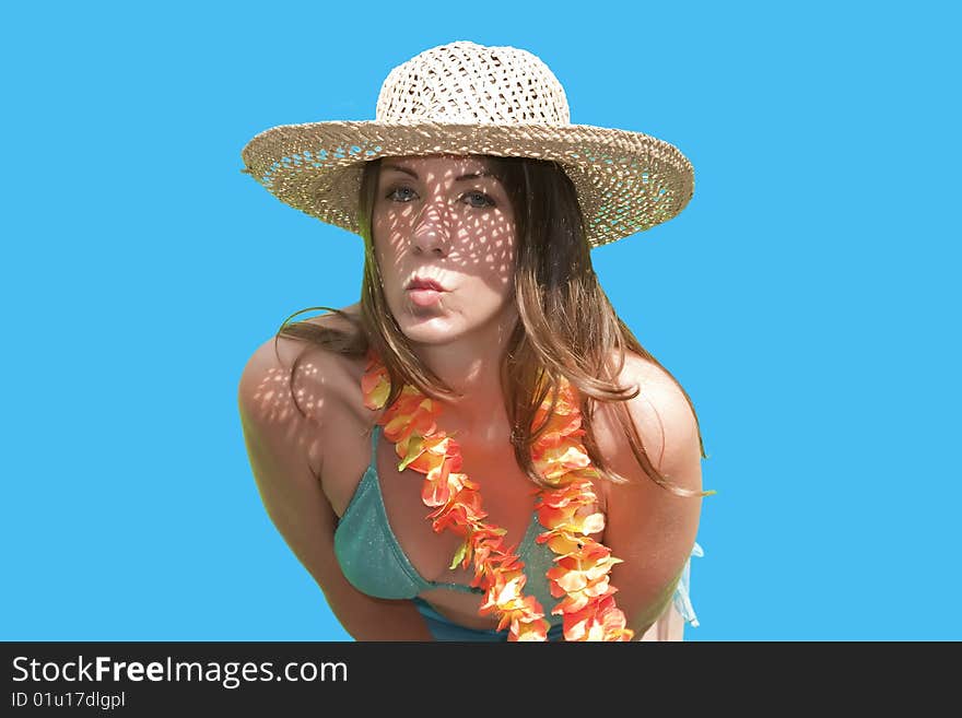 A pretty woman/girl in straw hat posing by blowing a kiss for her husband on a Hawaiian vacation. A pretty woman/girl in straw hat posing by blowing a kiss for her husband on a Hawaiian vacation.