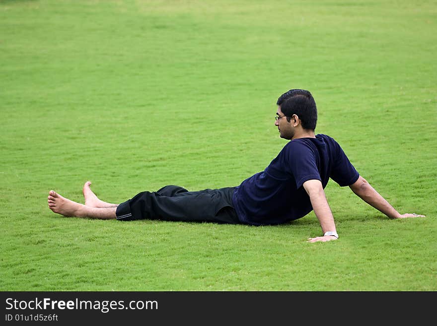 Men relaxation over grass