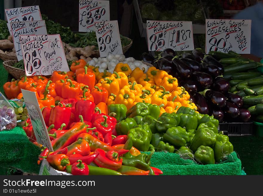 The vibrant colours of peppers and vegetables on a market stall