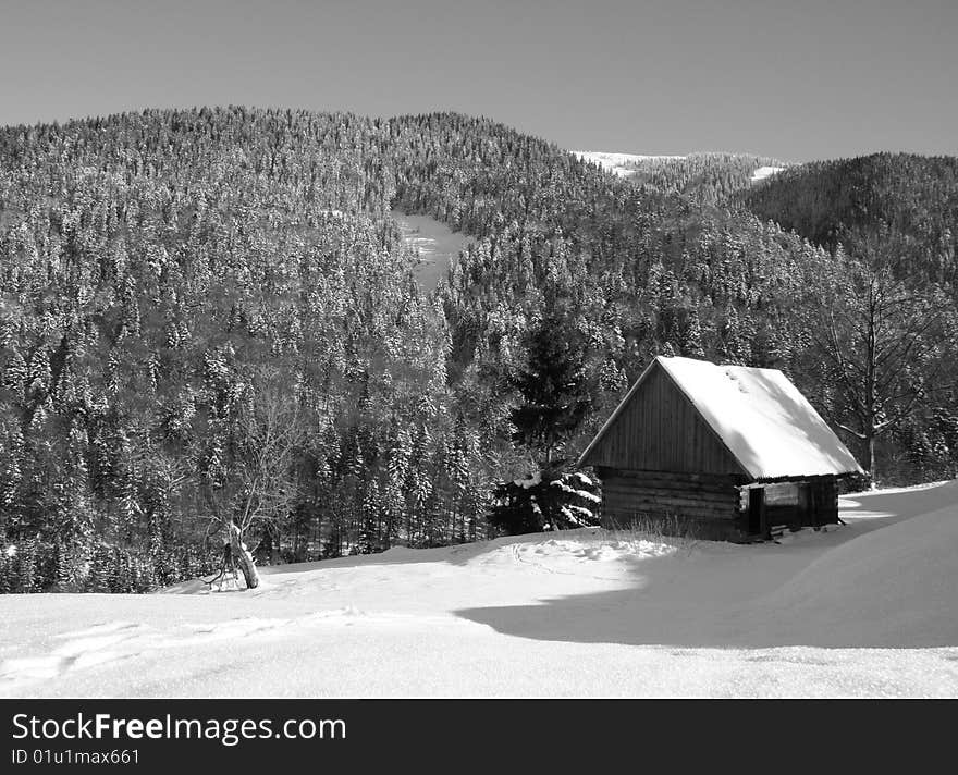 Small wooden house in winter mountains