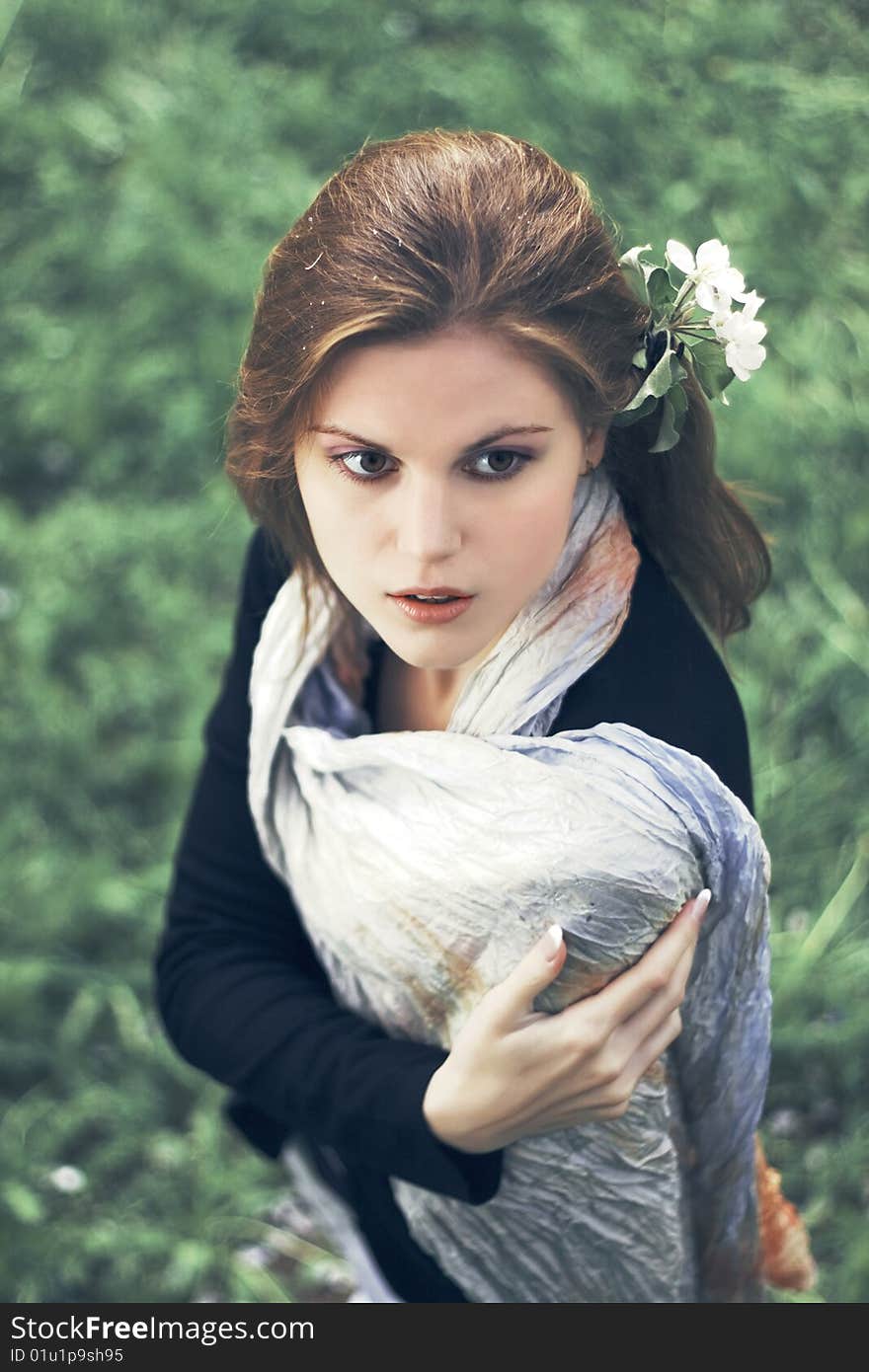 Portrait Of Young Woman With Flowers In Hair