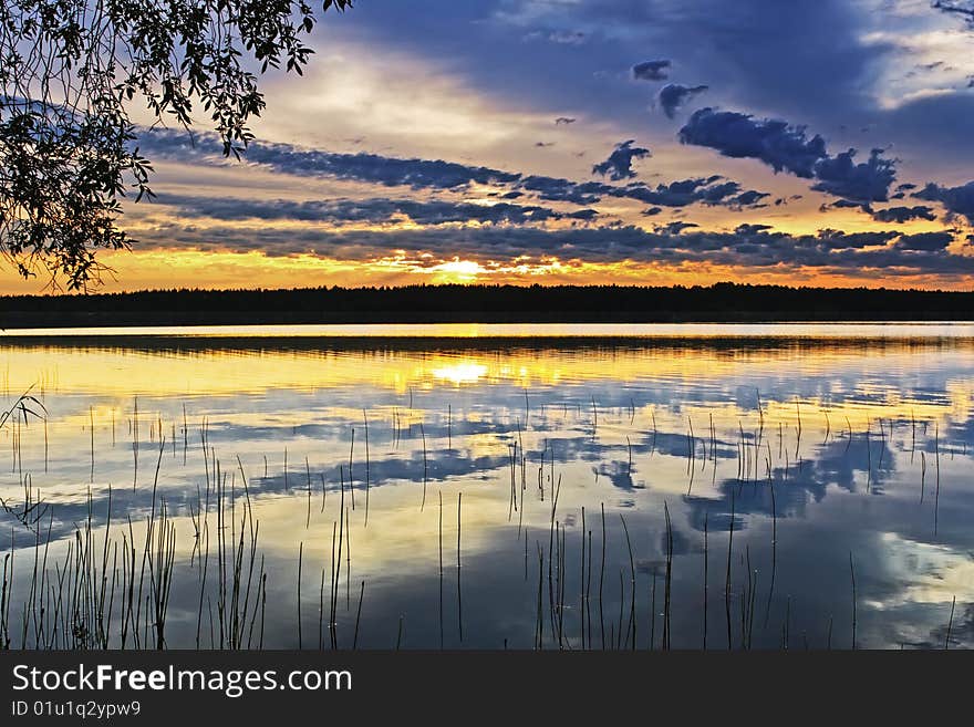 Still water, burning sunset and polar day. Still water, burning sunset and polar day