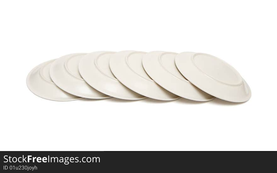 Stack of plain beige plates tiled upside down isolated. Stack of plain beige plates tiled upside down isolated