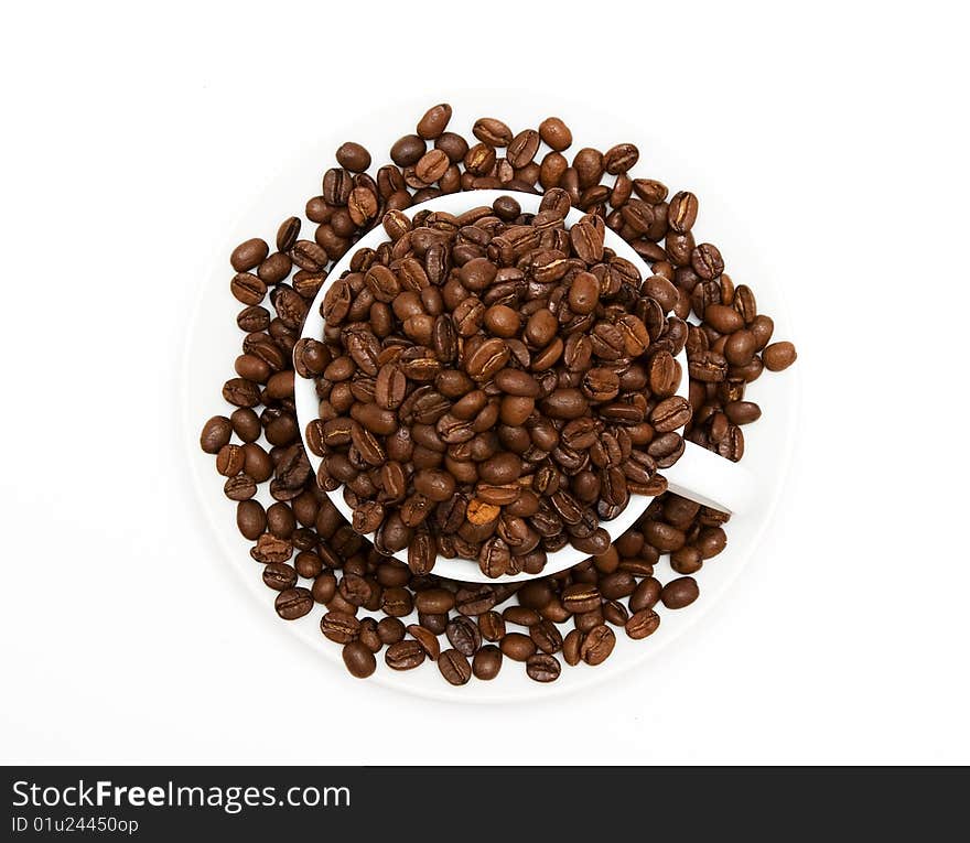 Mug filled with coffee beans, top view