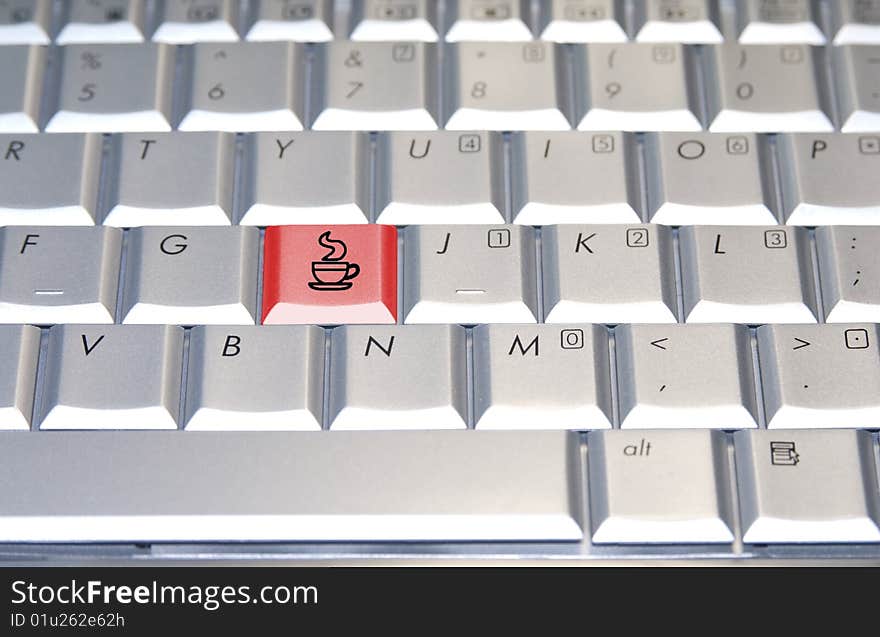 A red coffee key on a  gray keyboard. A red coffee key on a  gray keyboard