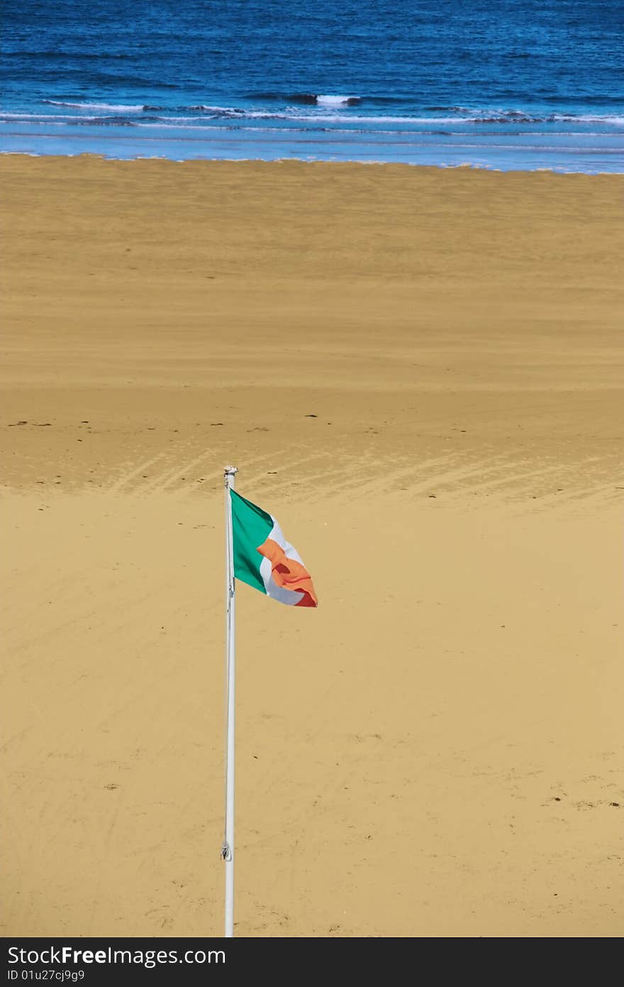 A view of the beach in ballybunion co kerry ireland with irish flag. A view of the beach in ballybunion co kerry ireland with irish flag