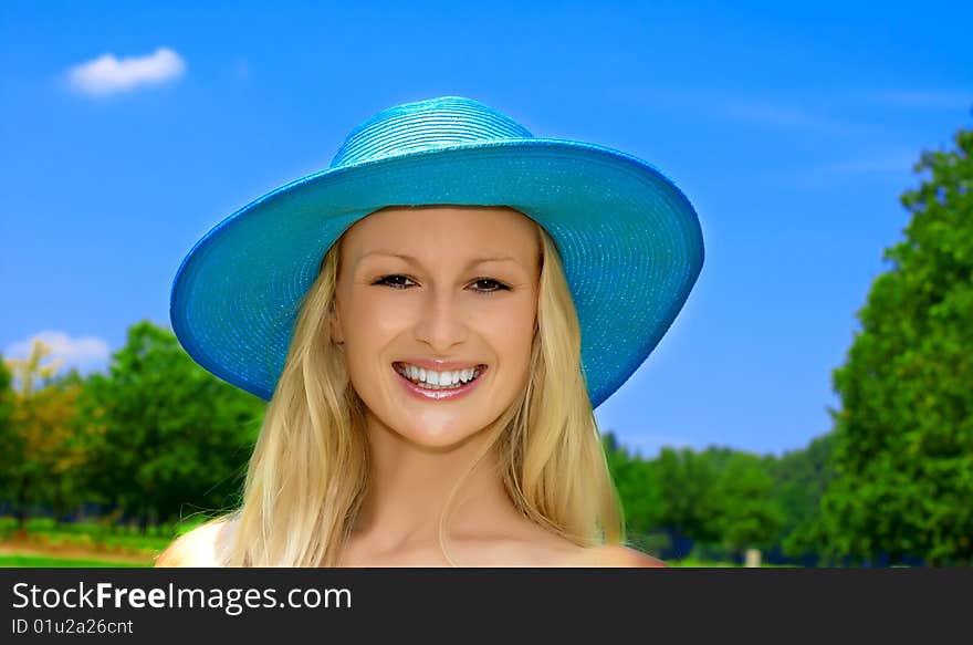 Closeup portrait of beautiful blond young woman with hat over blue sky background. Closeup portrait of beautiful blond young woman with hat over blue sky background.