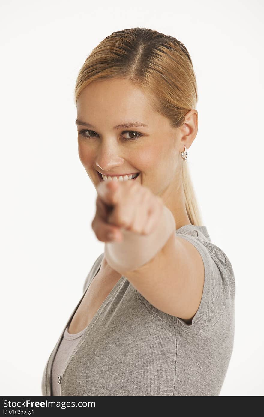 Young woman pointing at camera