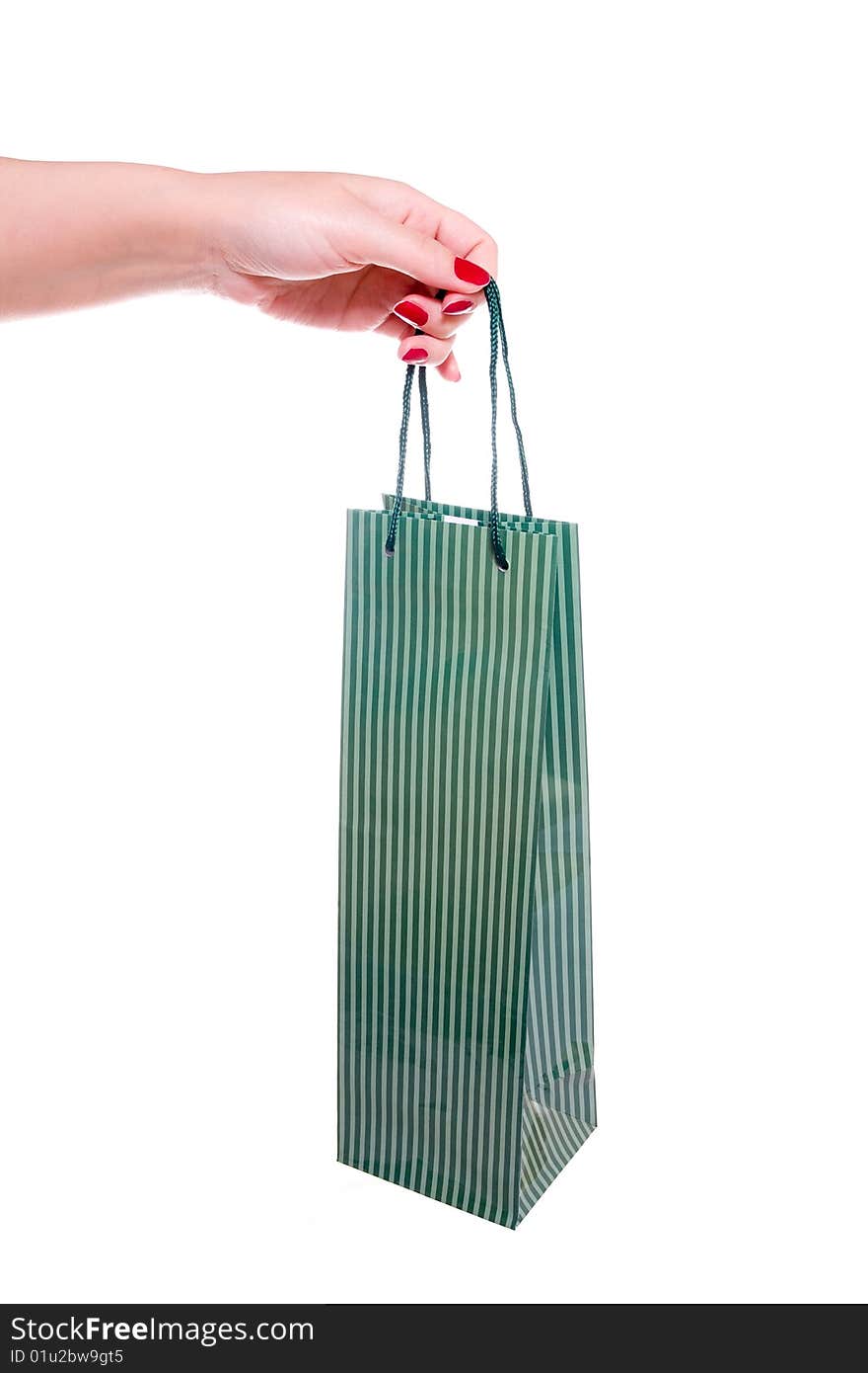 Hand holding green shopping bag on white background