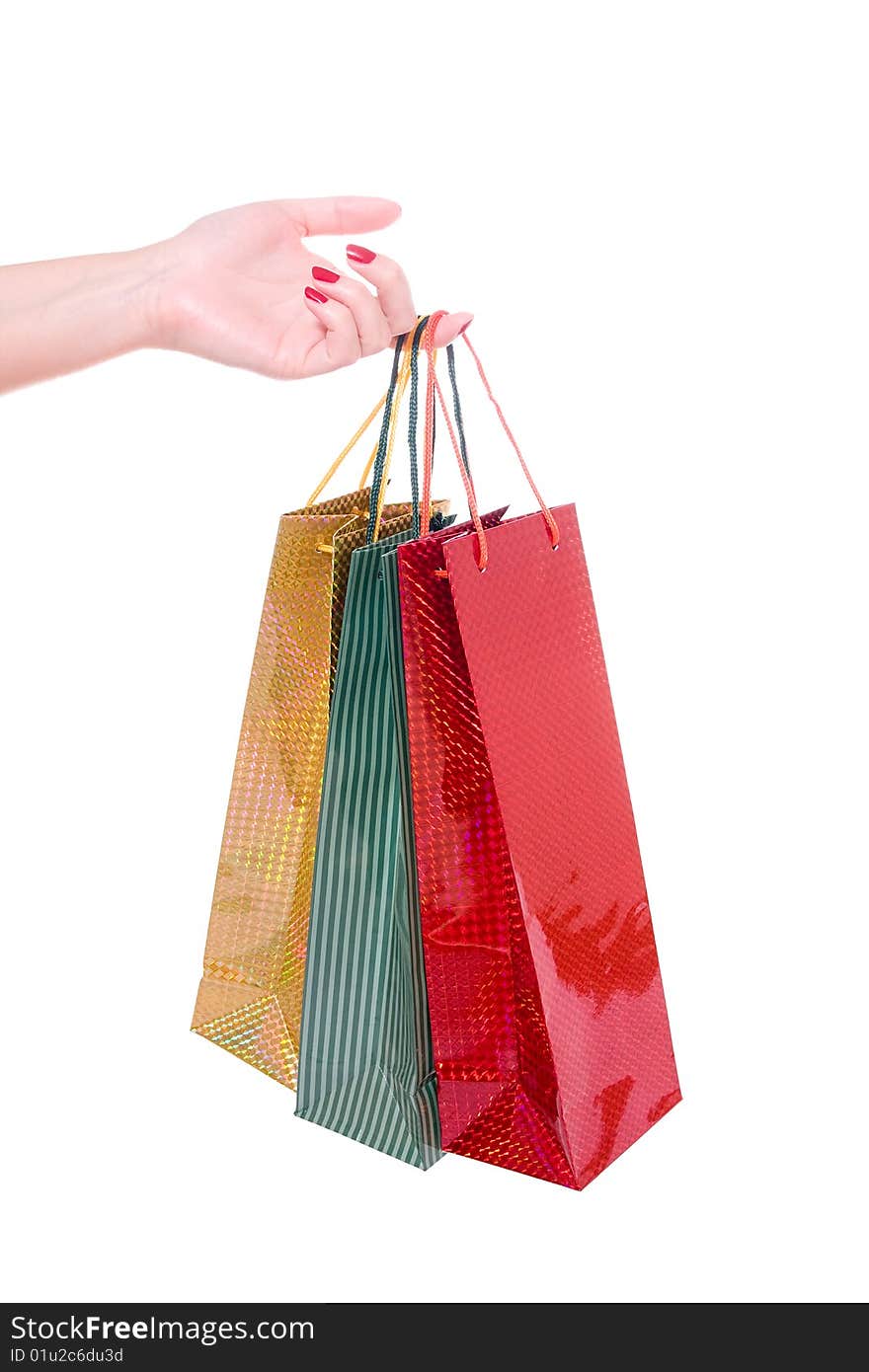Hand holding shopping bags on white background