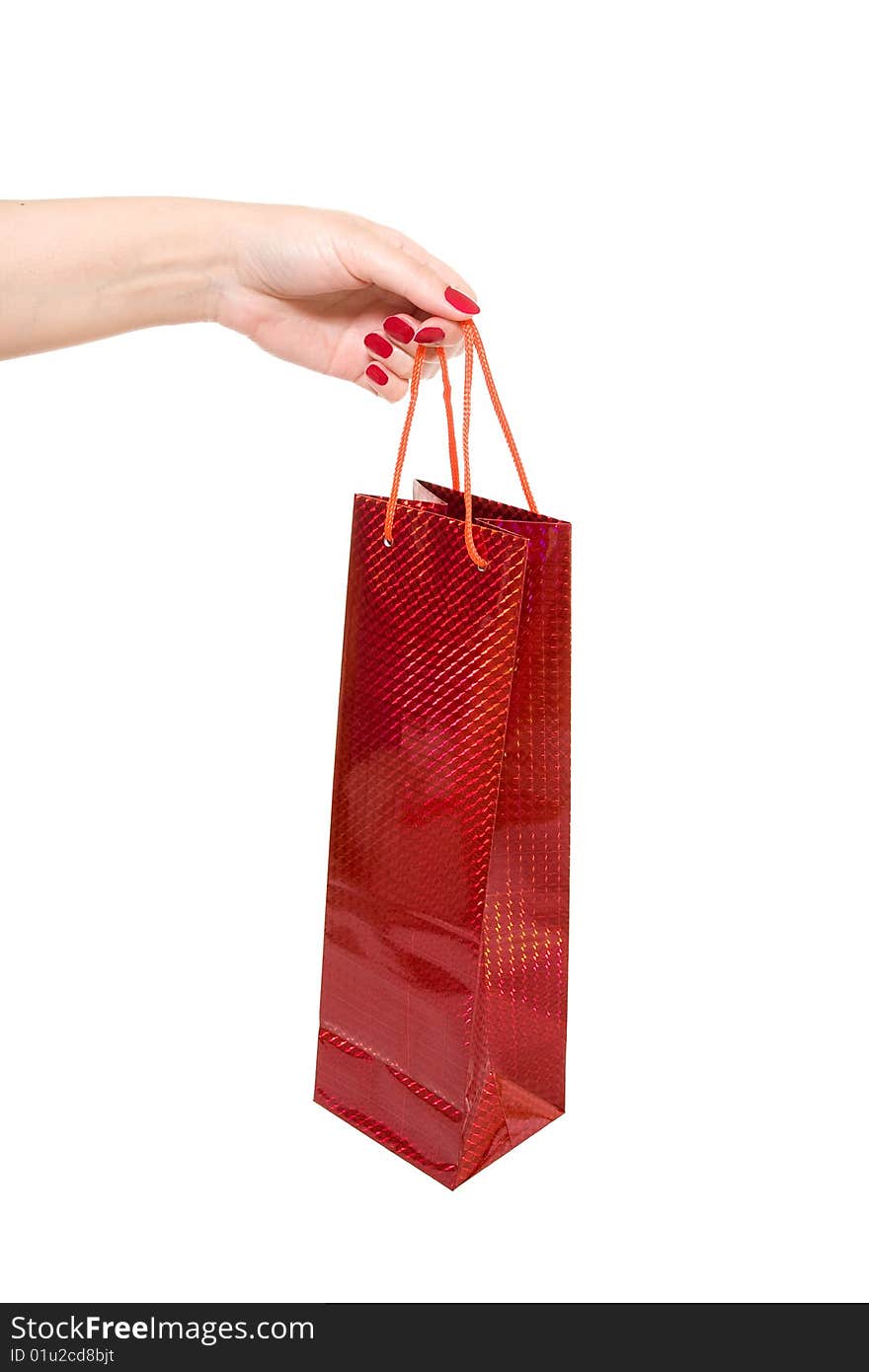 Hand holding red shopping bag on white background