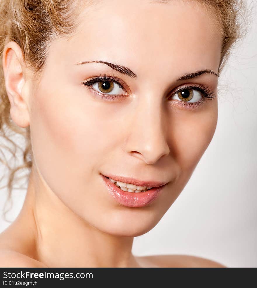 Closeup portrait of young blond smiling woman