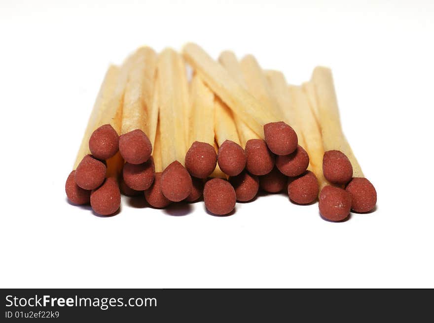 Amount of redheaded matches lying isolated on a white background