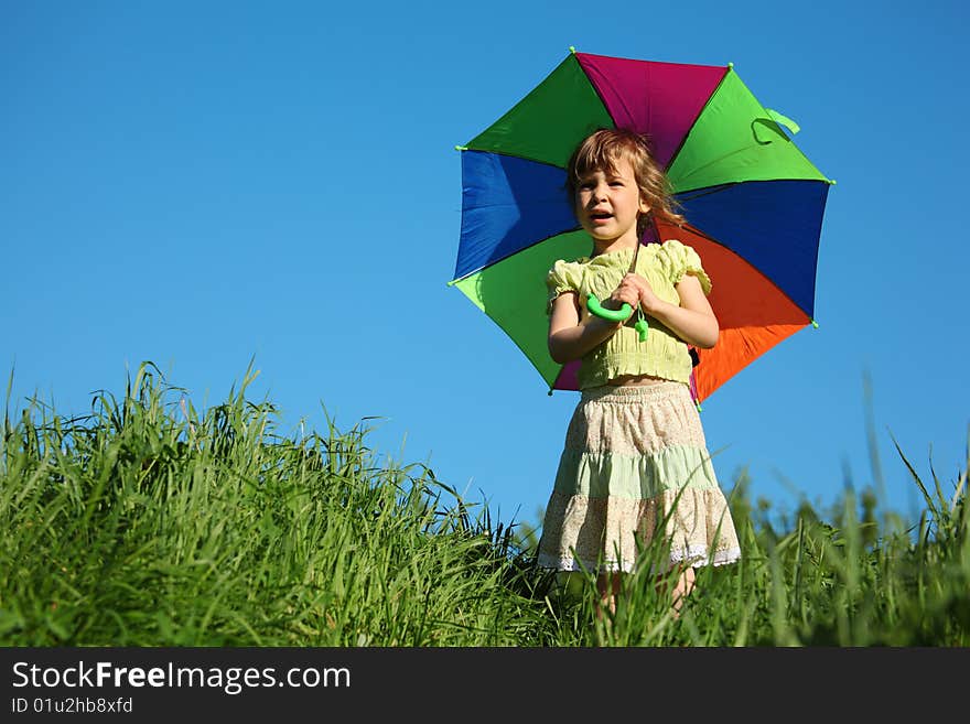 Girl With  Multicoloured Umbrella In Grass