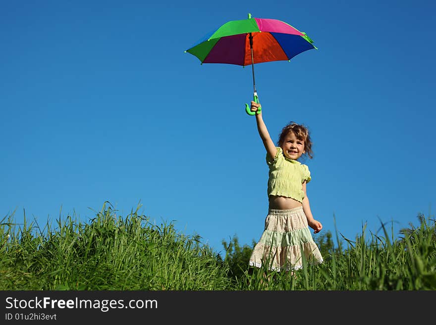 Girl with multicoloured umbrella in hand