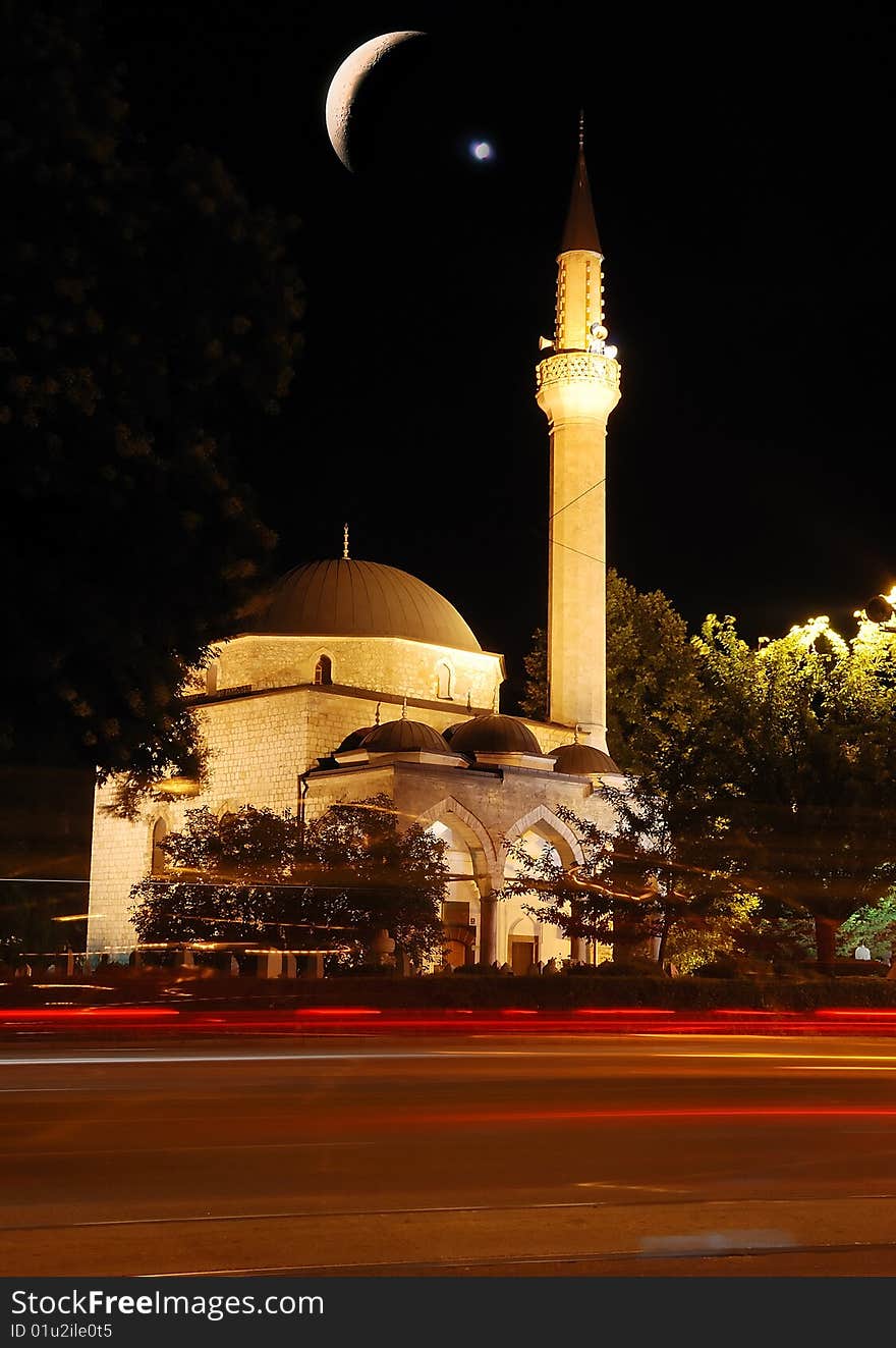 Mosque, crescent and star, traffic and lights at night