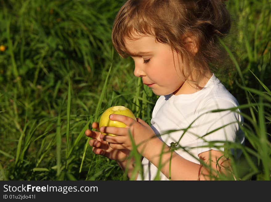 Girl In Grass With Green Apple