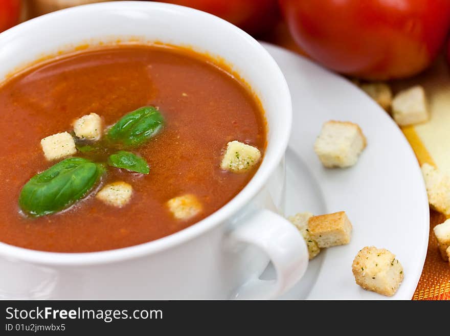 Tomato soup in white bowl