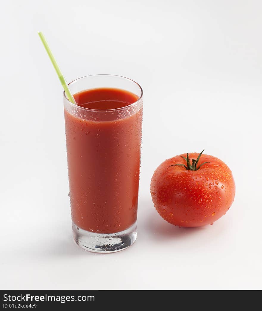 Glass with fresh tomato juice near the tomato